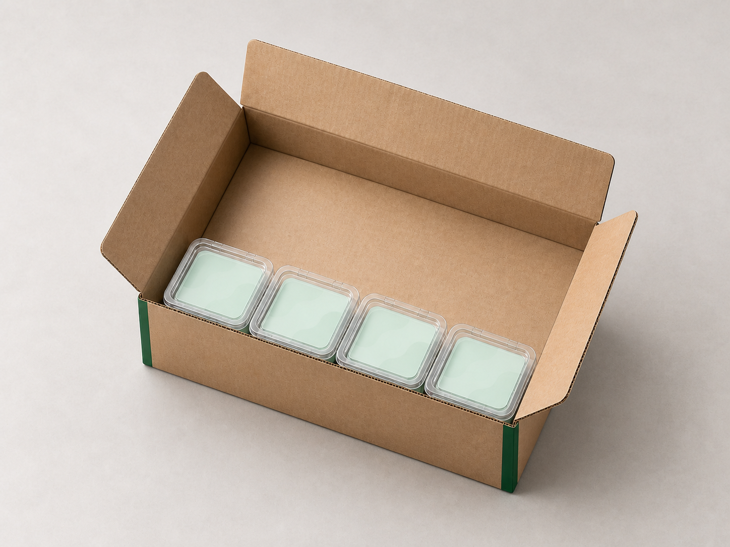 AI-generated illustrative view of four generic clear sample packs arranged as one first row in an open unbranded carton