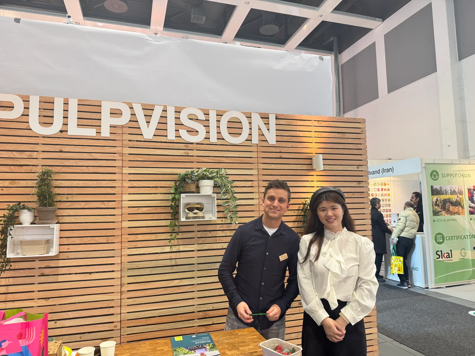 Two people meeting at an exhibition booth