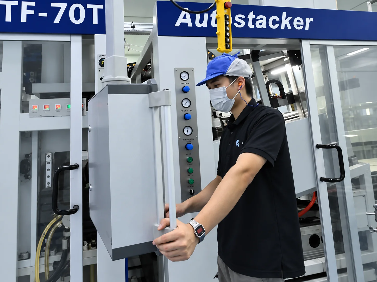 Operator beside the forming machine enclosure