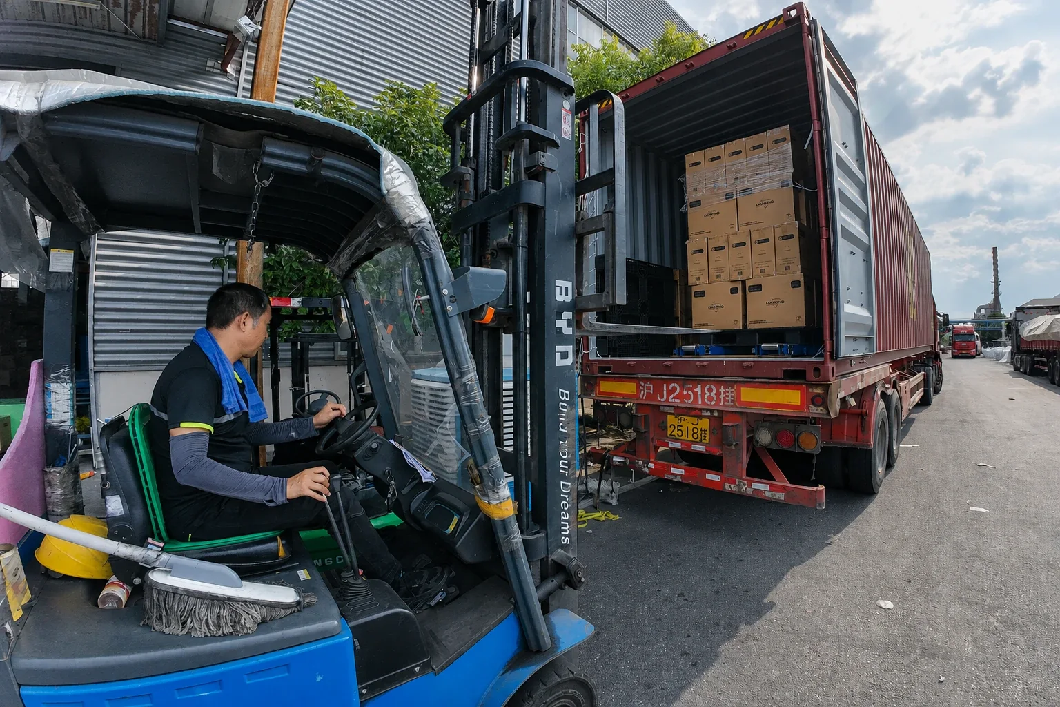 Forklift moving cartons into a shipping container