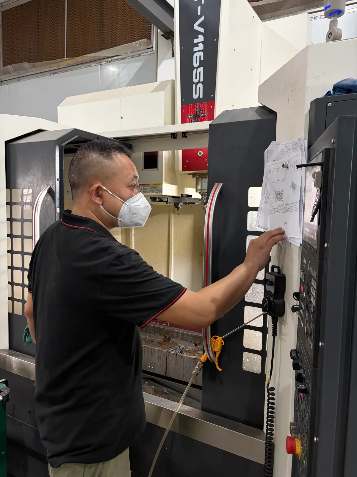 Operator setting up tooling with a drawing