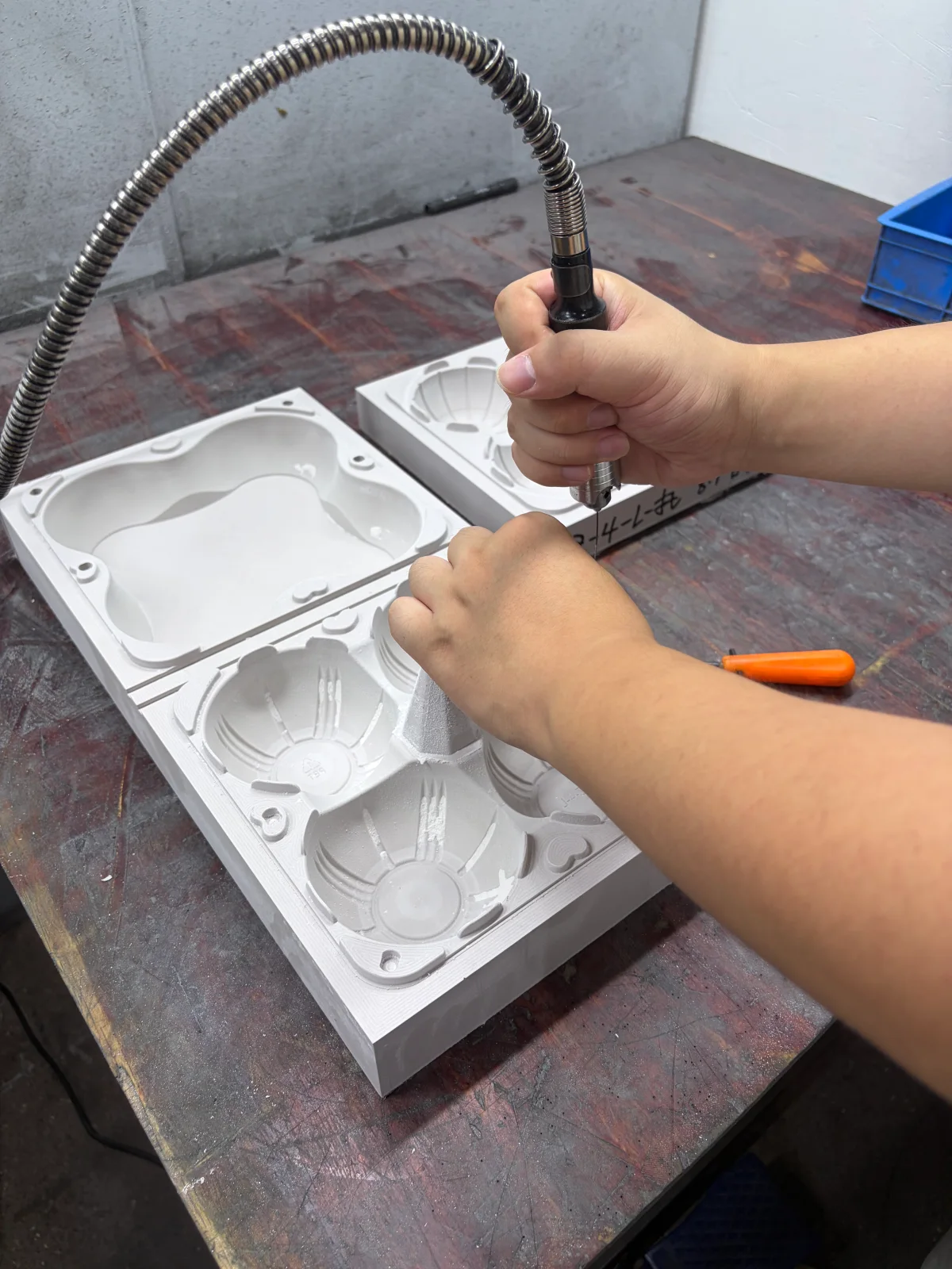 Hands finishing a white mold