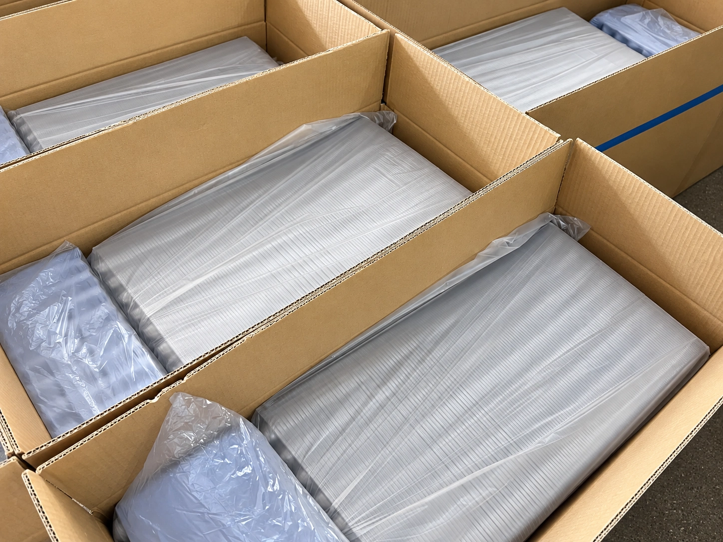 Clear trays nested in shipping cartons
