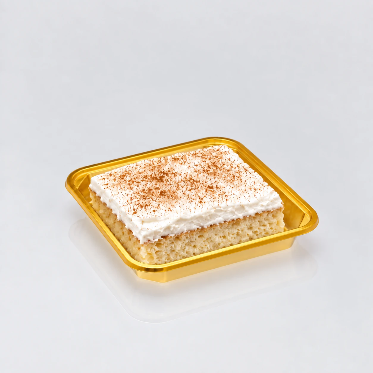 Square gold tray holding cream cake.