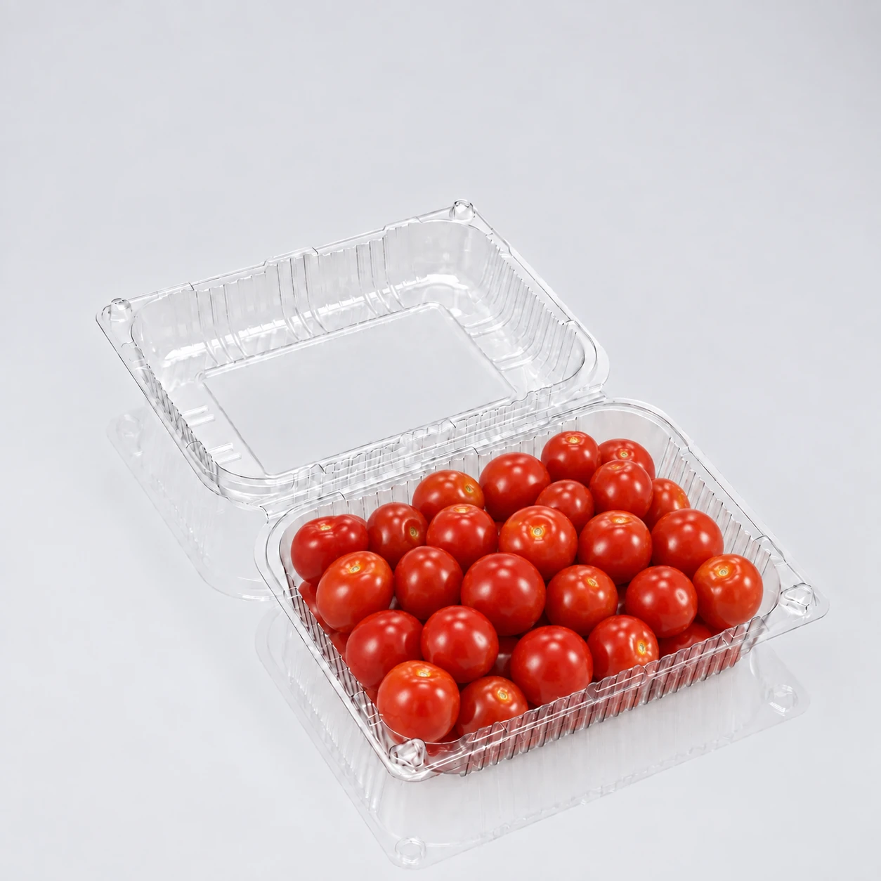Open clear ribbed hinged clamshell with red tomatoes; supplied filename XGL-1616P differs visually from gold tray in food folder; check old match.