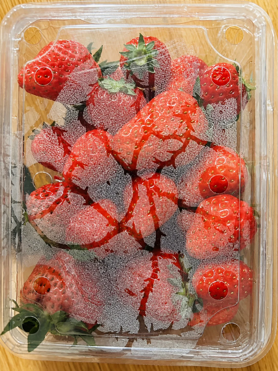 Drops inside a strawberry pack.